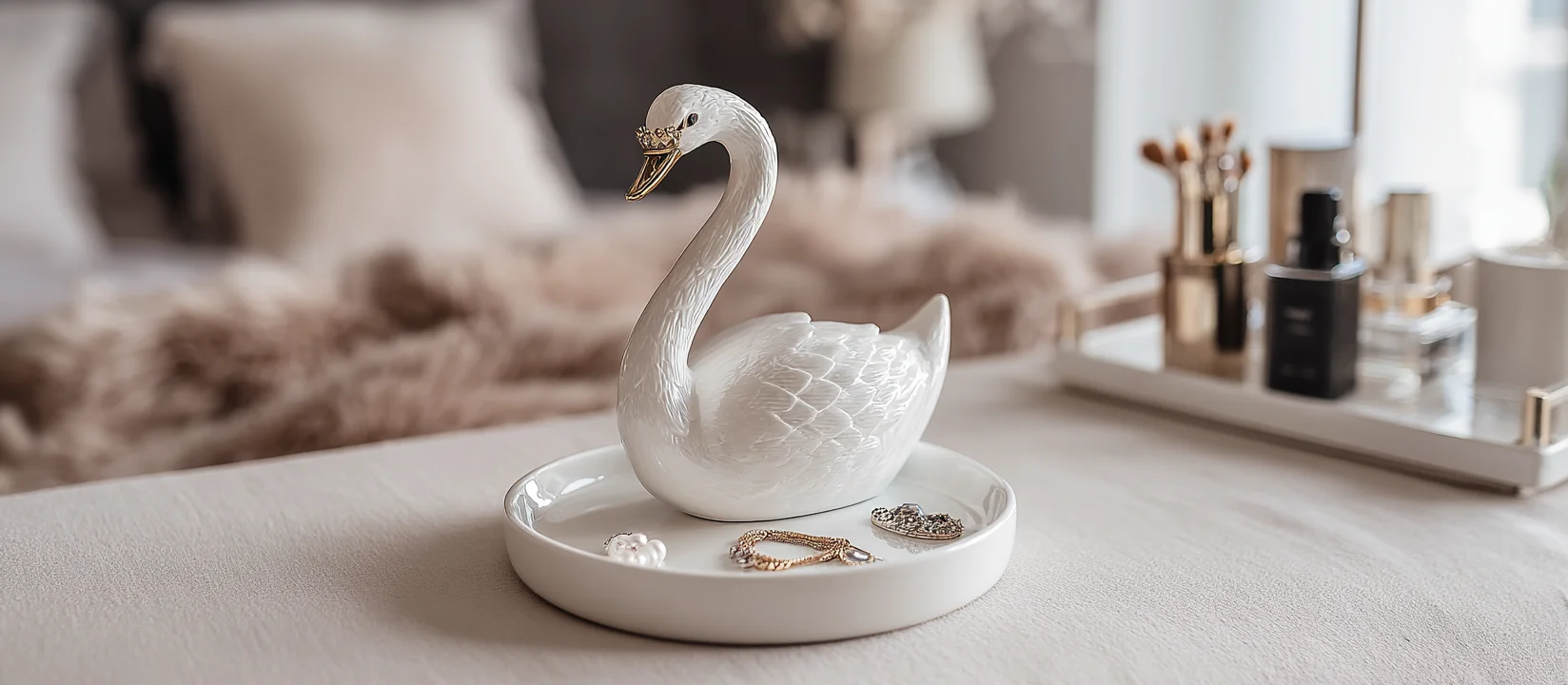 A minimalist metal ring stand with jewelry on a dark tray.